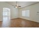 Open-concept living room with tile floors and archway to another room at 8733 W Laurel Ln, Peoria, AZ 85345
