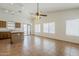 Open-concept living space featuring tile flooring, an island, and a kitchen at 8733 W Laurel Ln, Peoria, AZ 85345