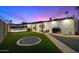 Beautiful backyard features a sparkling pool, lush grass, and covered patio for relaxing and entertaining at 10245 N 34Th Pl, Phoenix, AZ 85028