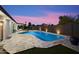 Beautiful backyard with a sparkling pool, travertine deck, and lush artificial grass at 10245 N 34Th Pl, Phoenix, AZ 85028