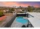Backyard view features a private pool surrounded by stone tile and green turf at 10245 N 34Th Pl, Phoenix, AZ 85028
