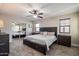 Bedroom featuring a large bed, a ceiling fan, and mirrored closet doors at 10245 N 34Th Pl, Phoenix, AZ 85028