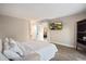A bright bedroom featuring wood-look tile floors and access to an ensuite bath at 10245 N 34Th Pl, Phoenix, AZ 85028
