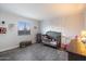 Cozy bedroom with stylish gray wood-look floors and decorative tree-themed wall art at 10245 N 34Th Pl, Phoenix, AZ 85028
