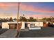 Exterior shot of a bright single-story home featuring desert landscaping, a modern garage, and an open patio at 10245 N 34Th Pl, Phoenix, AZ 85028