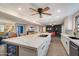 Beautiful open kitchen featuring a large island with bar seating, quartz countertops and modern appliances at 10245 N 34Th Pl, Phoenix, AZ 85028