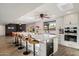 Modern kitchen featuring a large island with bar seating, white cabinetry, and stainless steel appliances at 10245 N 34Th Pl, Phoenix, AZ 85028