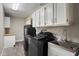 Functional laundry room features modern washer and dryer, ample cabinet storage, and a utility sink at 10245 N 34Th Pl, Phoenix, AZ 85028