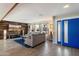Spacious living room features wood accent wall, neutral paint, tile floors, and abundant natural light at 10245 N 34Th Pl, Phoenix, AZ 85028