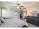 Spacious main bedroom features modern ceiling fan, wood-look floors, and a convenient office area at 10245 N 34Th Pl, Phoenix, AZ 85028