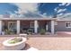 Inviting covered back patio area with comfortable seating and a charming fire pit feature at 1445 W Wood Dr, Phoenix, AZ 85029