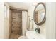 This neutral toned bathroom features a tiled walk-in shower, single sink vanity, and coordinating accents at 1445 W Wood Dr, Phoenix, AZ 85029