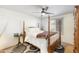 Elegant bedroom featuring a four-poster bed, neutral colors, and wood flooring at 1445 W Wood Dr, Phoenix, AZ 85029