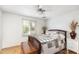 Inviting bedroom with wood floors, ceiling fan, and bright natural light at 1445 W Wood Dr, Phoenix, AZ 85029