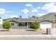 Charming single-story home with xeriscape landscaping and mature trees at 1445 W Wood Dr, Phoenix, AZ 85029