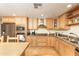 Bright kitchen features wood cabinets, granite counters, and stainless appliances at 1445 W Wood Dr, Phoenix, AZ 85029