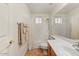 Clean bathroom with a shower-tub combo, white tile, and a wood vanity at 15695 W Earll Dr, Goodyear, AZ 85395