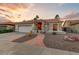 Charming home featuring desert landscaping and a two-car garage at 15695 W Earll Dr, Goodyear, AZ 85395