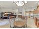 Open-concept living and kitchen area with neutral tile floors and modern appliances at 15695 W Earll Dr, Goodyear, AZ 85395