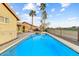 Sparkling pool and spa next to a covered patio with a golf course view at 15695 W Earll Dr, Goodyear, AZ 85395