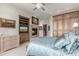 Primary bedroom with a cozy fireplace, mounted TV, and spacious wardrobe at 15802 N 71St St # 657, Scottsdale, AZ 85254