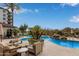 Resort-style pool area with palm trees, waterfall feature, and ample seating at 15802 N 71St St # 657, Scottsdale, AZ 85254