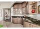 Elegant wet bar area with decorative cabinets and granite countertop at 15802 N 71St St # 657, Scottsdale, AZ 85254