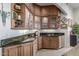 Stylish wet bar area featuring glass cabinets and granite countertops at 15802 N 71St St # 657, Scottsdale, AZ 85254