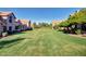 Community green space and walking paths lined with attractive homes and mature trees, perfect for enjoying the outdoors at 1633 E Lakeside Dr # 143, Gilbert, AZ 85234