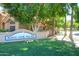 Inviting 'Beach Club Village' sign amidst lush greenery creating a welcoming community entrance at 1633 E Lakeside Dr # 143, Gilbert, AZ 85234