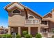 Charming two-story home featuring a red tile roof and desert landscaping at 1633 E Lakeside Dr # 143, Gilbert, AZ 85234