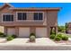 Charming townhome showcasing a neat driveway and well-maintained landscaping at 1633 E Lakeside Dr # 143, Gilbert, AZ 85234