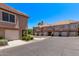 Attractive condo complex with tile roof, private garages, and lush landscaping creating a desirable living environment at 1633 E Lakeside Dr # 143, Gilbert, AZ 85234