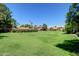 Expansive green space with manicured grass and mature trees, perfect for outdoor activities and relaxation at 1633 E Lakeside Dr # 143, Gilbert, AZ 85234