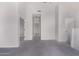 Open living space with neutral walls and carpet shows entry to more rooms at 1633 E Lakeside Dr # 143, Gilbert, AZ 85234