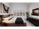 Serene main bedroom with a king-size bed, modern decor, and a window with shutter blinds at 1633 E Lakeside Dr # 143, Gilbert, AZ 85234