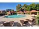Community pool surrounded by lounge chairs and cabanas, creating a resort-like atmosphere for residents at 1633 E Lakeside Dr # 143, Gilbert, AZ 85234
