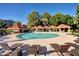 Resort-style community pool and cabanas surrounded by lush landscaping, offering a luxurious outdoor experience at 1633 E Lakeside Dr # 143, Gilbert, AZ 85234