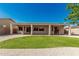 Enjoy your low maintenance backyard, featuring a covered patio, and lush green grass at 16837 W Northampton Rd, Surprise, AZ 85374
