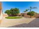 Enjoy the spacious low maintenance backyard, featuring a variety of trees and landscaping elements at 16837 W Northampton Rd, Surprise, AZ 85374