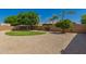 Backyard landscape with gravel and a small patch of green grass at 16837 W Northampton Rd, Surprise, AZ 85374