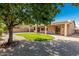 Enjoy a private low maintenance backyard with mature landscaping, a covered patio, and ample space for outdoor activities at 16837 W Northampton Rd, Surprise, AZ 85374