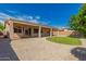 Expansive backyard features a covered patio, low-maintenance landscaping, and clear blue skies at 16837 W Northampton Rd, Surprise, AZ 85374