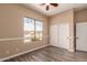 This bedroom features a window view, a closet with sliding doors, and a ceiling fan at 16837 W Northampton Rd, Surprise, AZ 85374