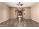 Bedroom featuring wood-look flooring, neutral walls, ceiling fan, and sliding glass door at 16837 W Northampton Rd, Surprise, AZ 85374