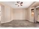 Bedroom features wood-look flooring, neutral walls, ceiling fan, and sliding glass door at 16837 W Northampton Rd, Surprise, AZ 85374