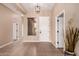 Inviting entryway with tile flooring, neutral walls, and a decorative light fixture at 16837 W Northampton Rd, Surprise, AZ 85374