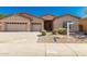 Charming single-story home with a three-car garage, low maintenance landscaping, and neutral color palette at 16837 W Northampton Rd, Surprise, AZ 85374