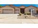 Charming single-story home with a three-car garage, low maintenance landscaping, and neutral color palette at 16837 W Northampton Rd, Surprise, AZ 85374