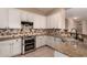 Well-equipped kitchen with stainless steel appliances, granite counters, and ample cabinet space at 16837 W Northampton Rd, Surprise, AZ 85374